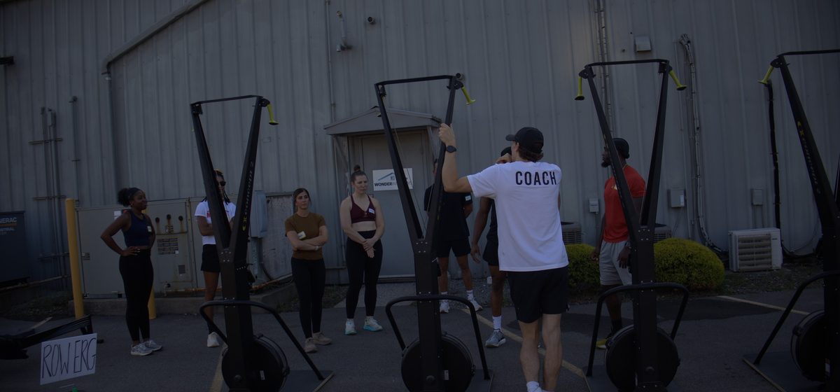 A coach briefing the class before a workout