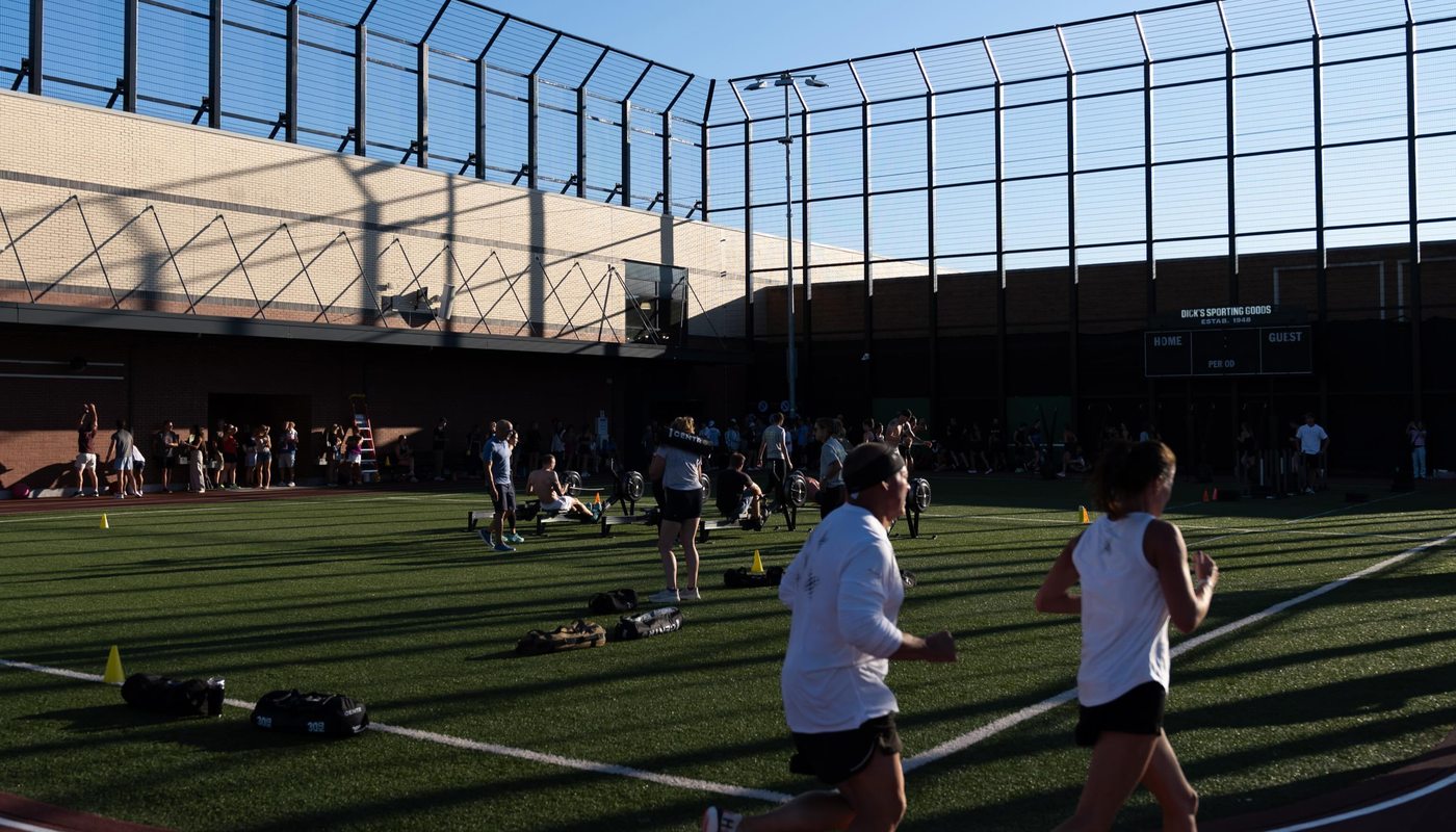 Athletes running the outdoor track at the HYROX Simulation at Dick's House of Sport
