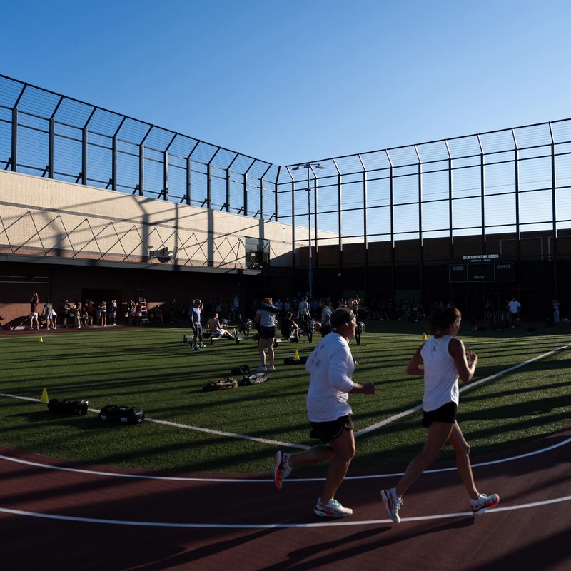 Athletes running the outdoor track during the simulation