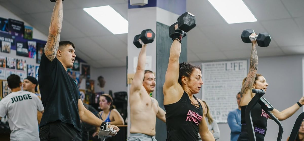 A class working through dumbbell presses together
